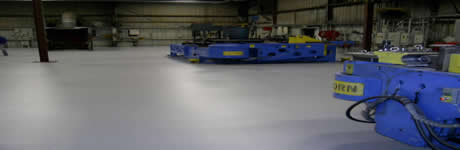 application of epoxy flooring solutions on a concrete floo